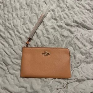 Light pink blush colored coach wristlet